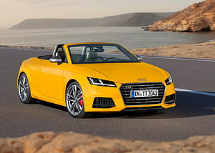 yellow Audi convertible car near body of water during day time HD wallpaper