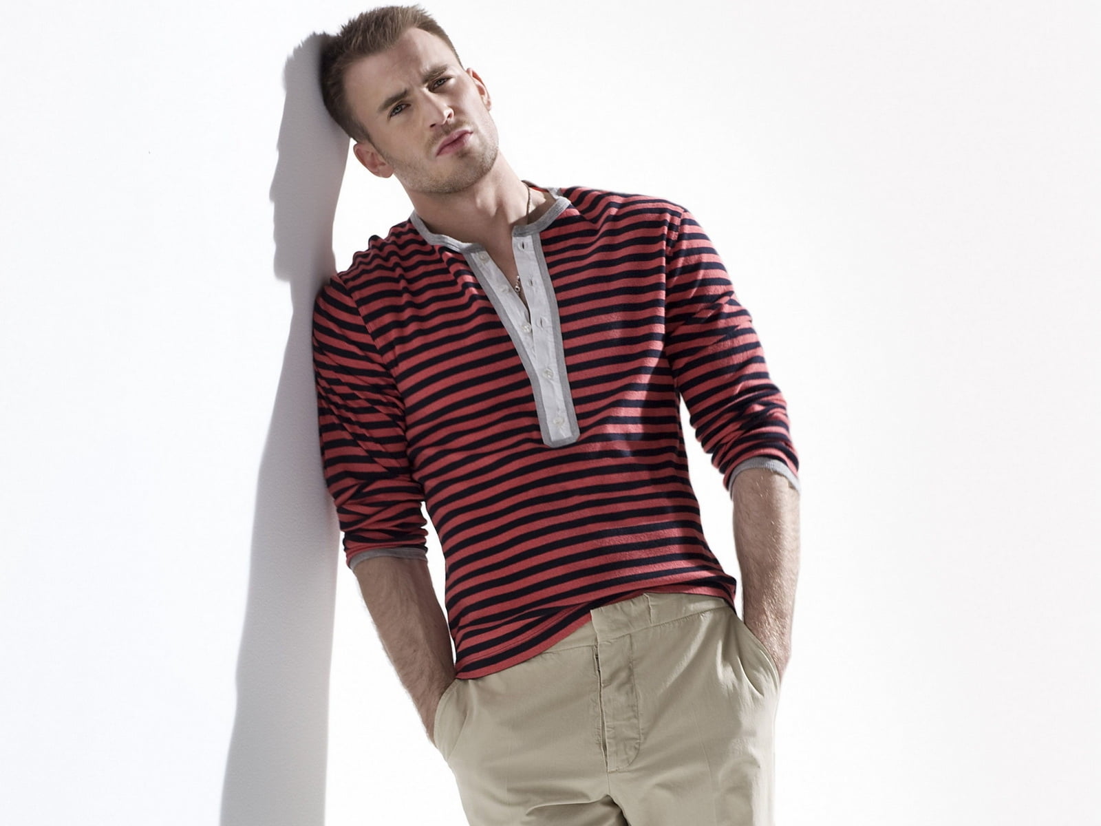 Man wearing black and red striped up-button shirt leaning on wall HD ...