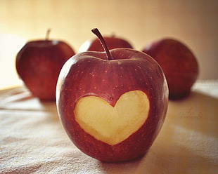Apple fruit with carved heart-shape photography