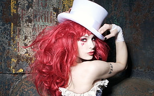 red haired woman wearing white top hat