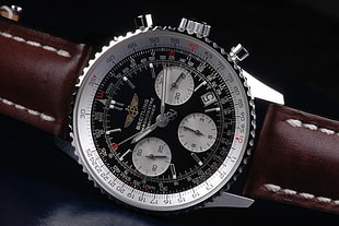 round silver chronograph watch with black leather strap, watch, luxury watches, Breitling
