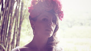 woman with red and pink Roses headdress near open field