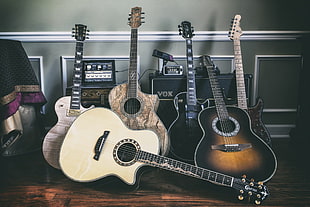 six assorted-color acoustic guitars