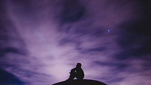 man sitting on ground, photography, purple, violet, silhouette