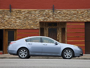 gray sedan parked in front of building