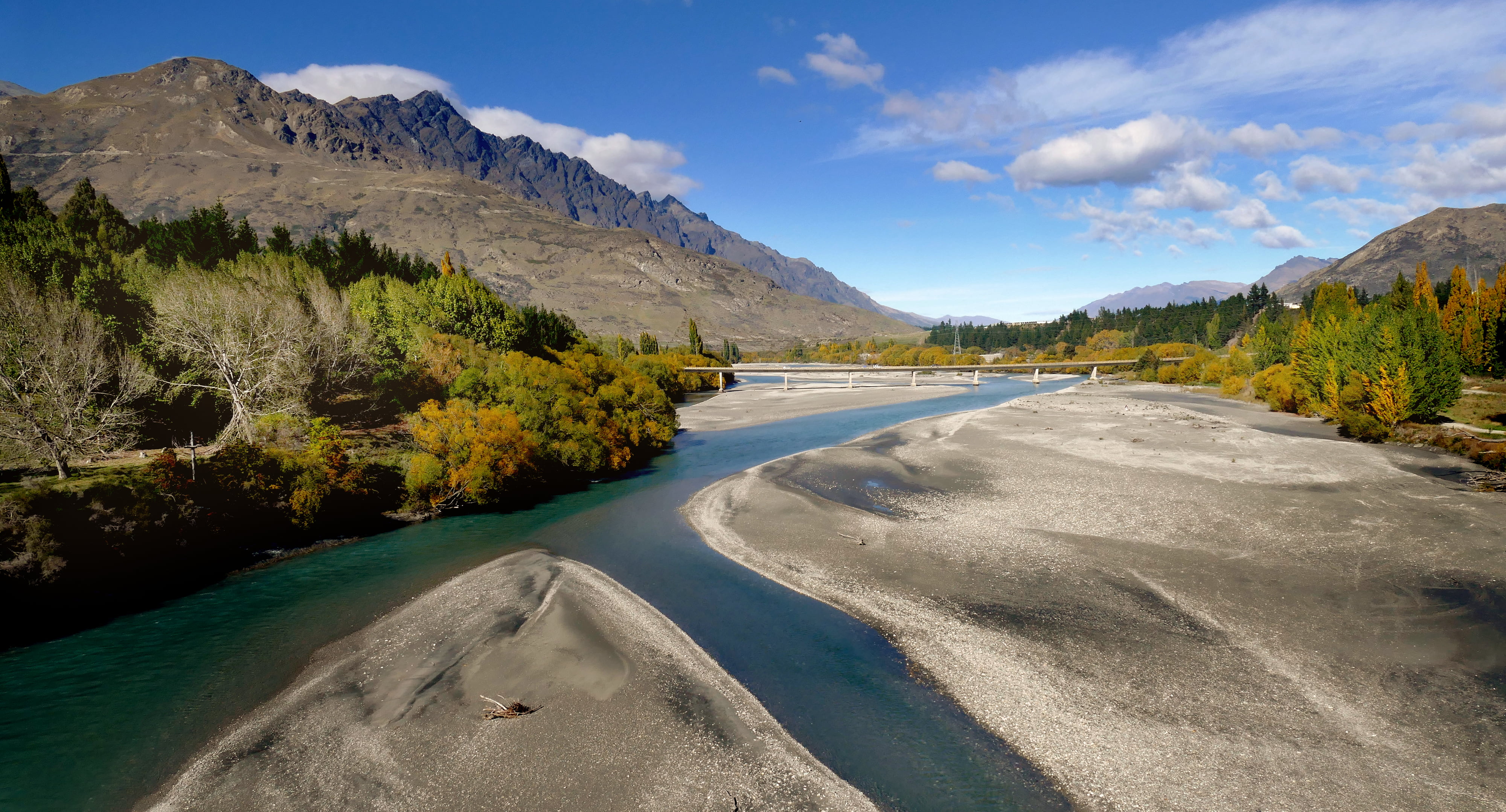 body of water between trees and hills under white clouds during daytime, shotover river