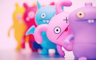 selective focus photo of pink monster animated illustration