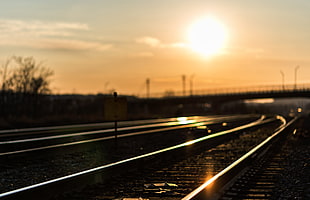 shallow focus on train rails during sunset