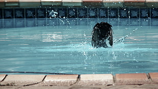 photo of person swimming in the pool