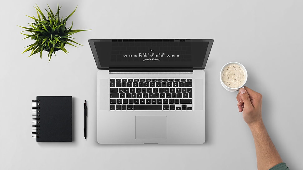 MacBook Pro on white table HD wallpaper