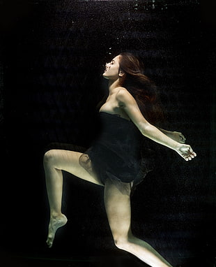 woman in black strapless mini dress in water