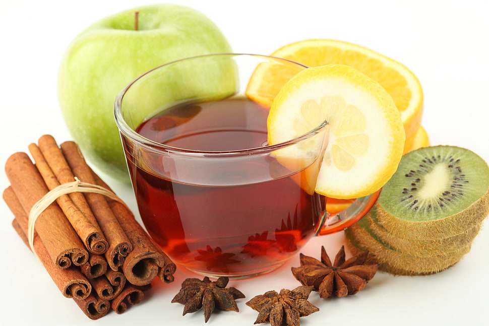 tea filled clear glass teacup HD wallpaper
