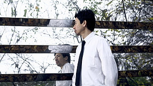 man wearing white dress shirt and black necktie