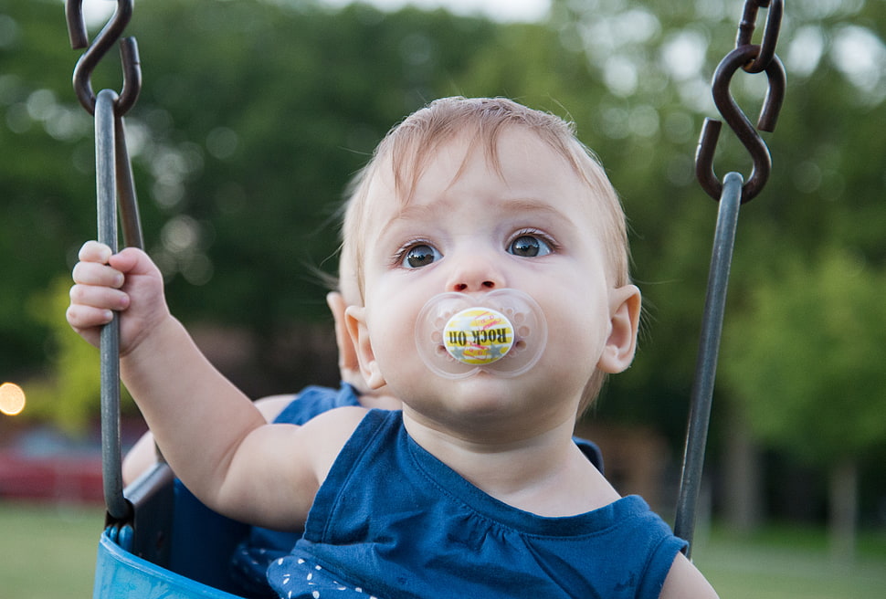 baby with pacifier on swing HD wallpaper