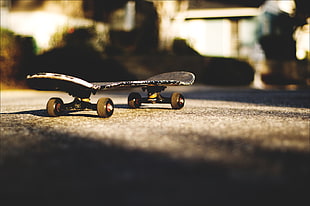focus photo of black skateboard