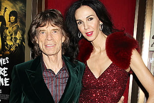 man wearing green blazer near woman wearing red v-neck dress