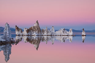 white and brown rock formation in the middle of ocean view in panoramic photography, mono lake