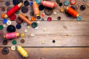button and thread lot on brown wooden board HD wallpaper