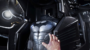 person holding Bat suit HD wallpaper