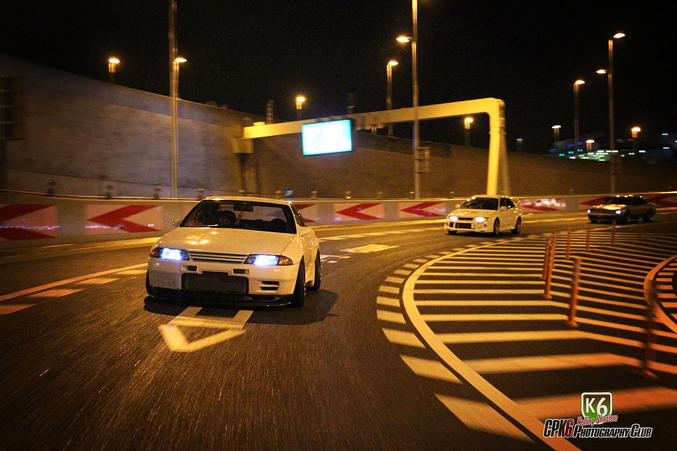 three cars racing at night HD wallpaper