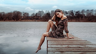 woman in brown dress sitting on boat dock HD wallpaper