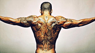 topless man with koi fish back tattoo