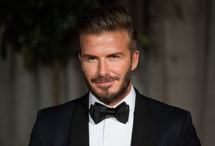 David Beckham wearing black formal suit jacket and black bow tie