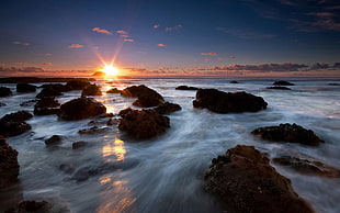 silhouette panoramic photography of sea with rocks HD wallpaper