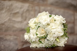 white petaled flower bouquet on wooden surface