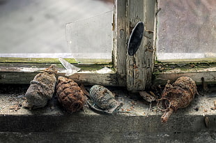 five gray and brown grenades, old, rust, ruin, abandoned