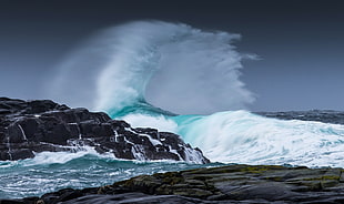 timelapse photography of seawaves on rock mountain
