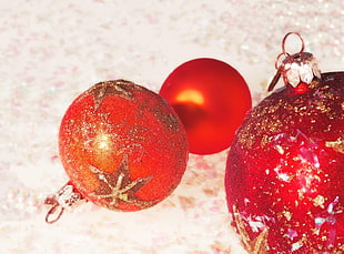 three red Christmas ornaments HD wallpaper