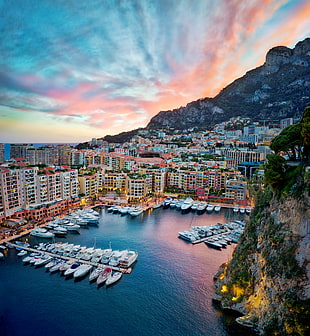 aerial photography of high rise building near boats and mountain at daytime, monte carlo