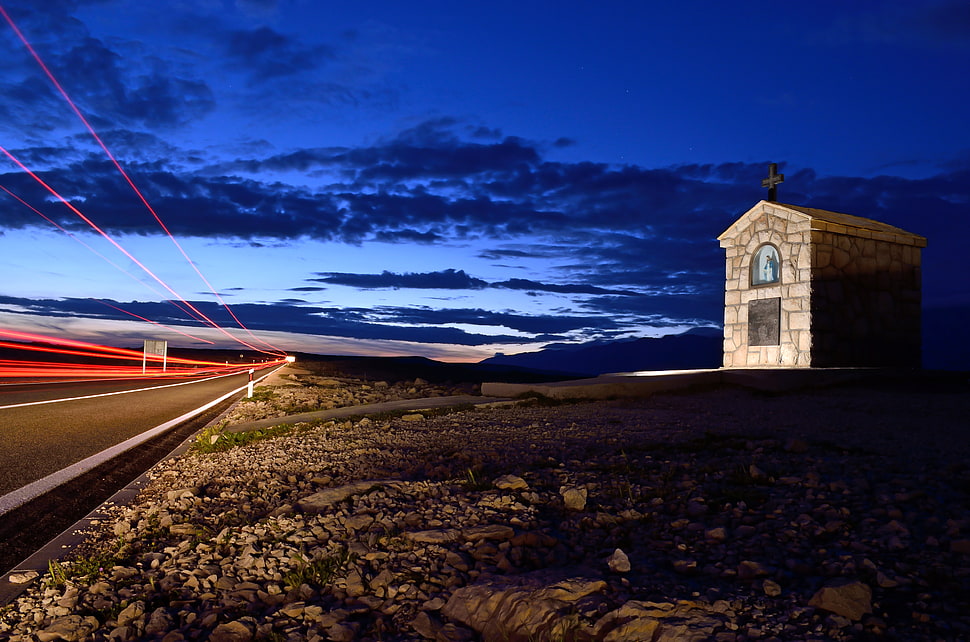 photo of white concrete chapel near road at night HD wallpaper