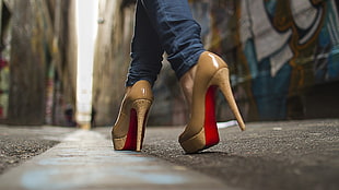 woman wearing pair of brown-and-red platform stilettos