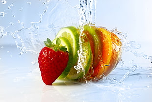 slice of citrus fruit and strawberry with splash of water