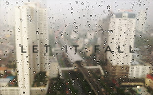 Let it Fall text, water on glass, blurred, city, typography