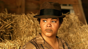 woman wearing gray collared shirt and black hat