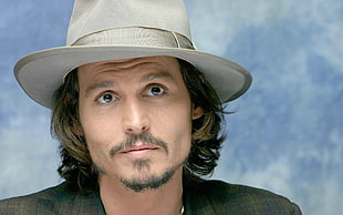 Johnny Depp in gray coat and white fedora