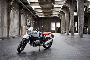 white and black standard backbone motorcycle on gray factory HD wallpaper