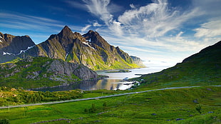 green field, mountains, road, clouds, bay HD wallpaper