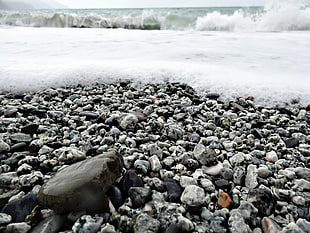 ocean wave on ocean rocks in closeup photography