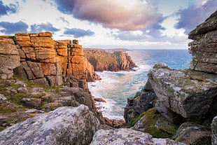 panoramic photo of rocks and beach during daytime