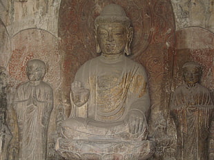 three brown concrete Buddha statues