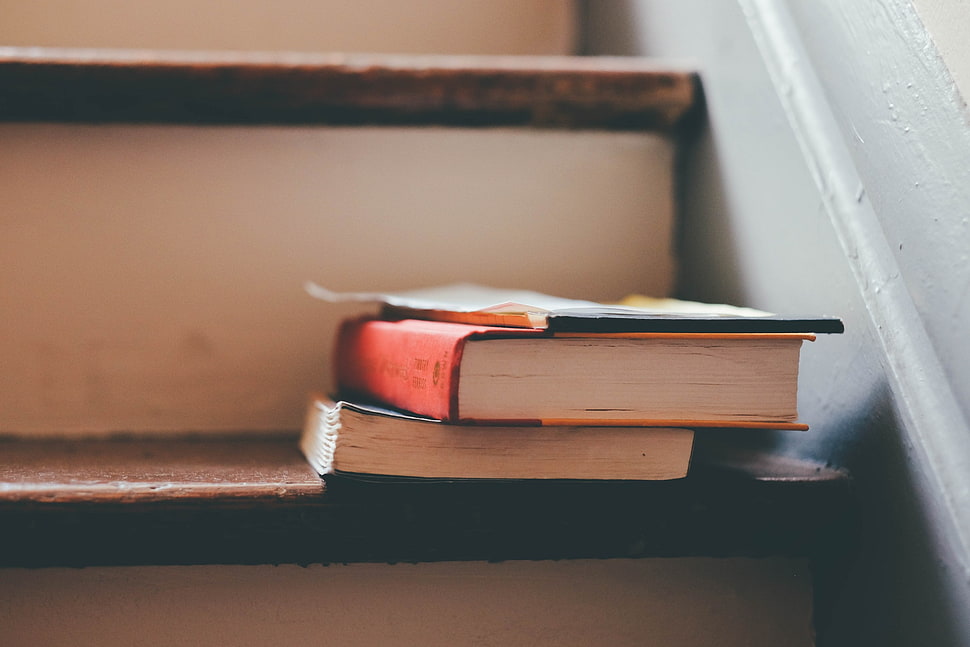 shallow focus photography of books on stairs HD wallpaper