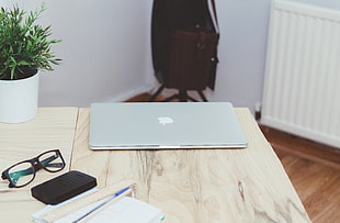 MacBook Pro;and black framed eyeglasses