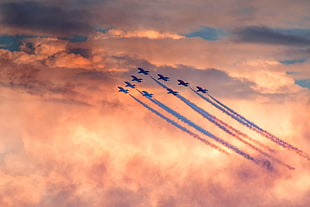 fighting planes with contrails with cloudy skies HD wallpaper