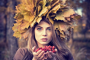 woman wearing brown top with maple leaves on her head