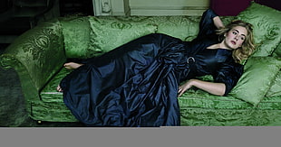 woman lying on sofa arms on head back