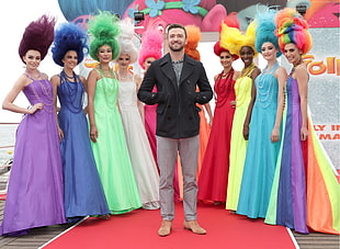 Justin Timberlake standing between nine women